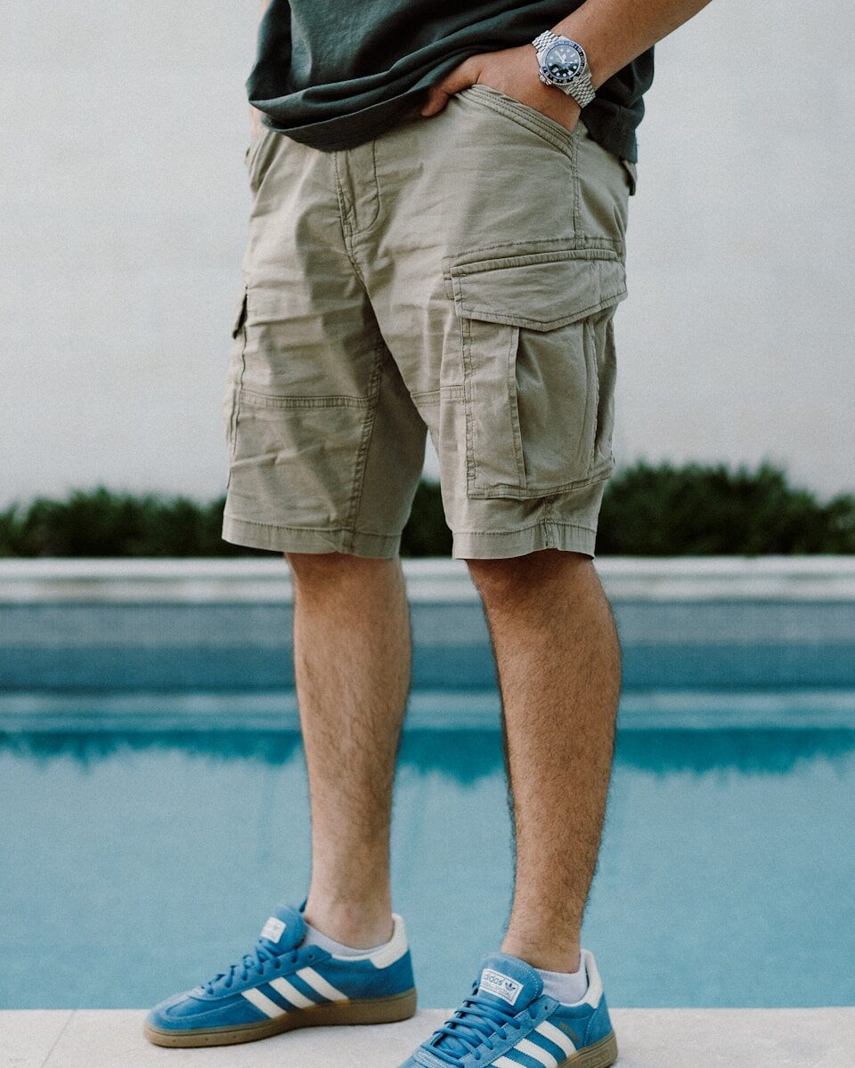 A man standing next to a swimming pool