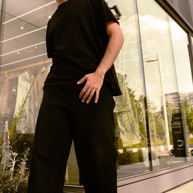 A man standing in front of a tall building